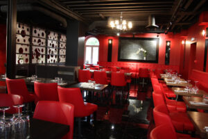 Elegant restaurant with red chairs and black accents.